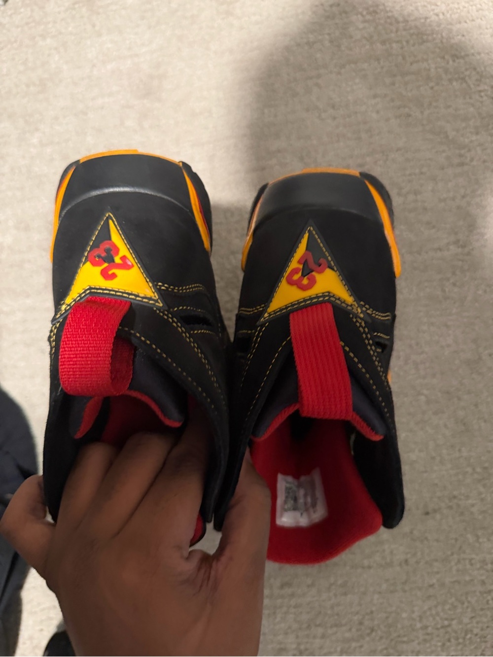 Jordan Black Sneakers with Red Pull Tabs and Yellow Accents